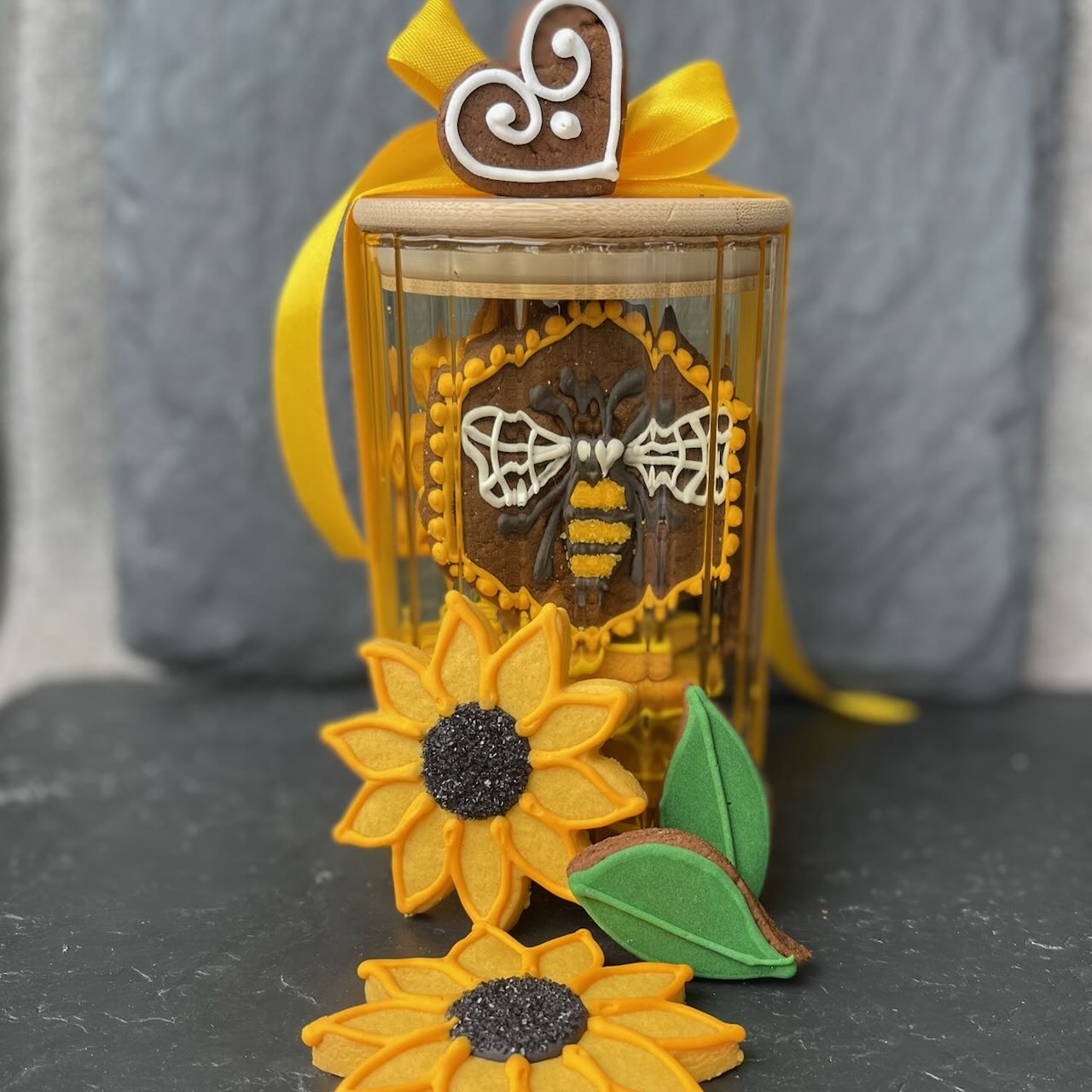 Bees and Sunflower biscuits in a pretty, yellow tinted glass biscuit jar by Sweet Snowdonia